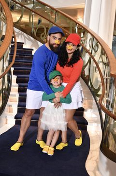 Our family aboard a cruise ship in red, blue, and green caps